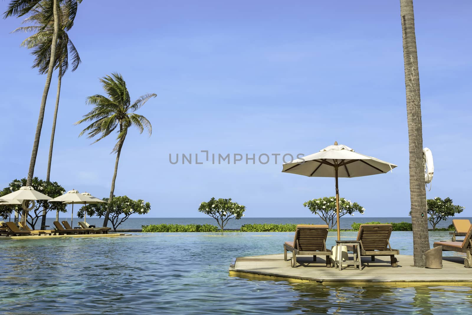 Perfect beach swimming pool with tropical resort relax.