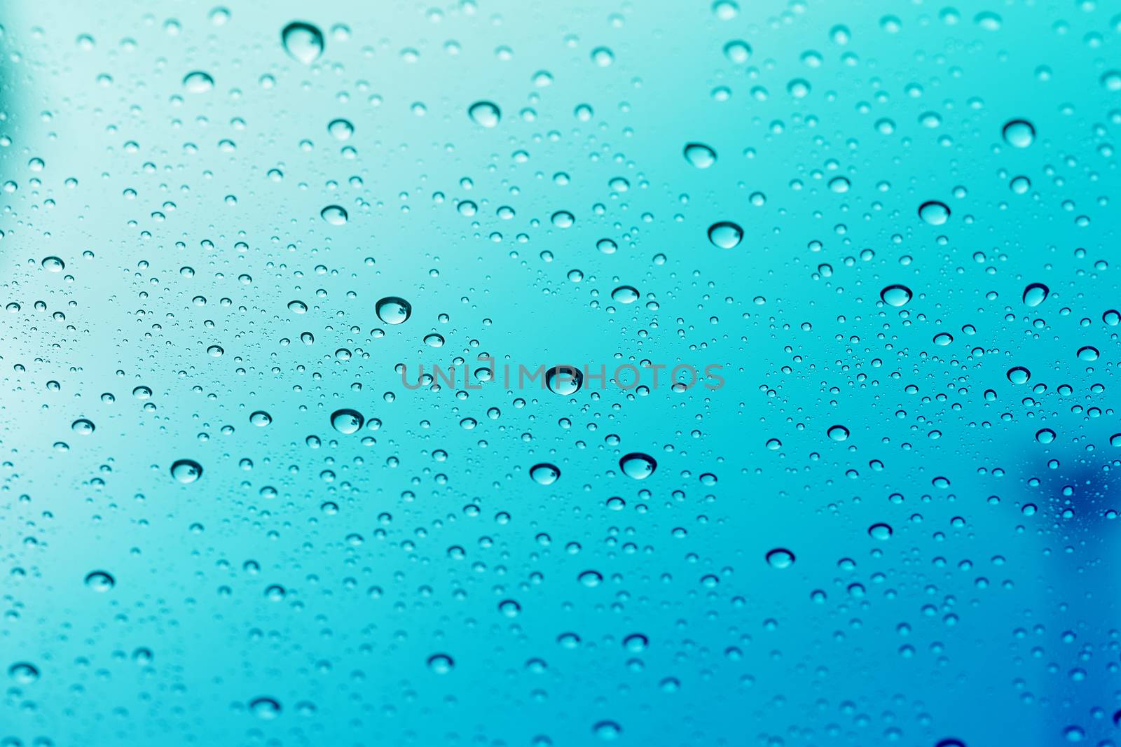 Water drop on glass mirror background. by jayzynism