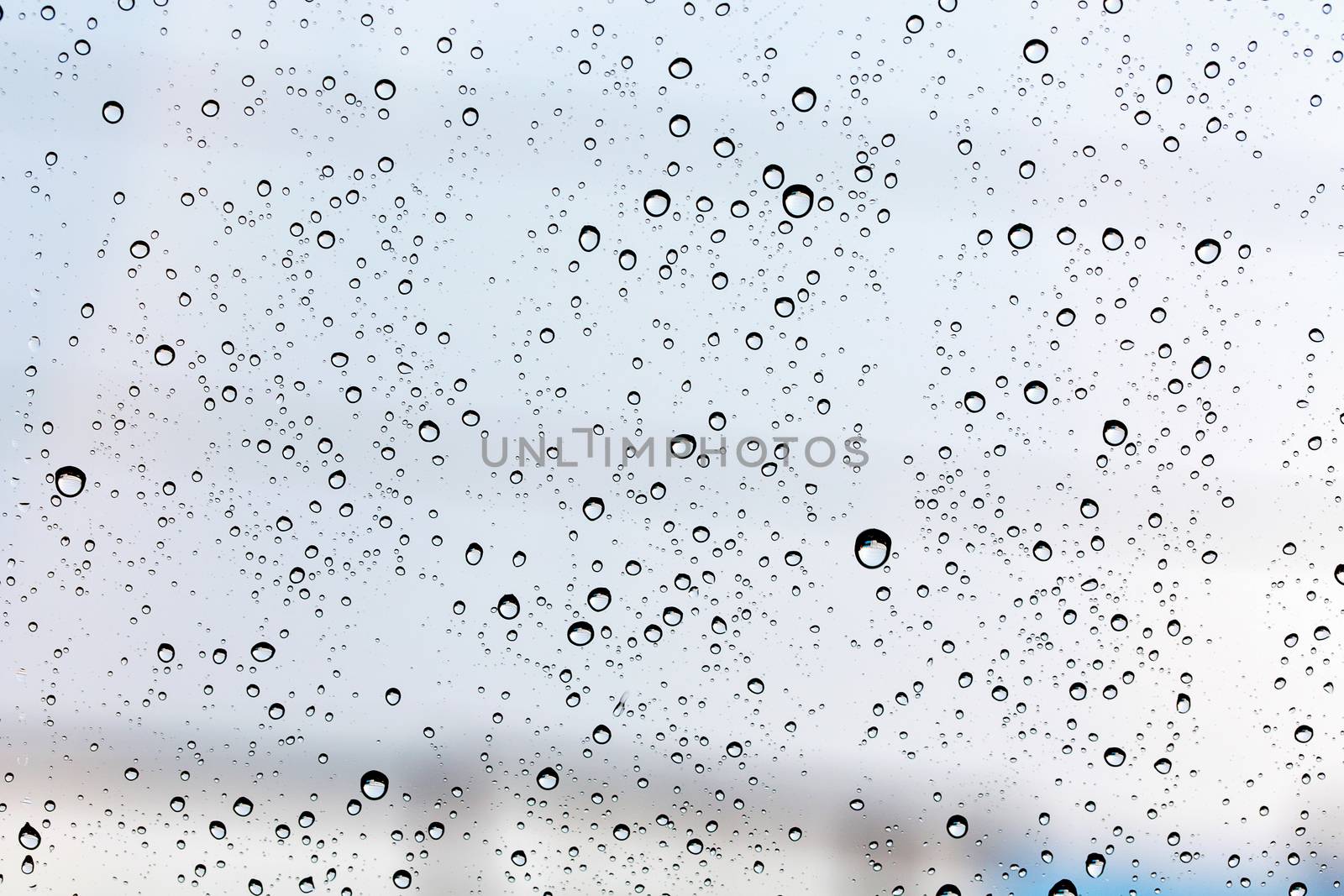 Water drop on glass mirror background.