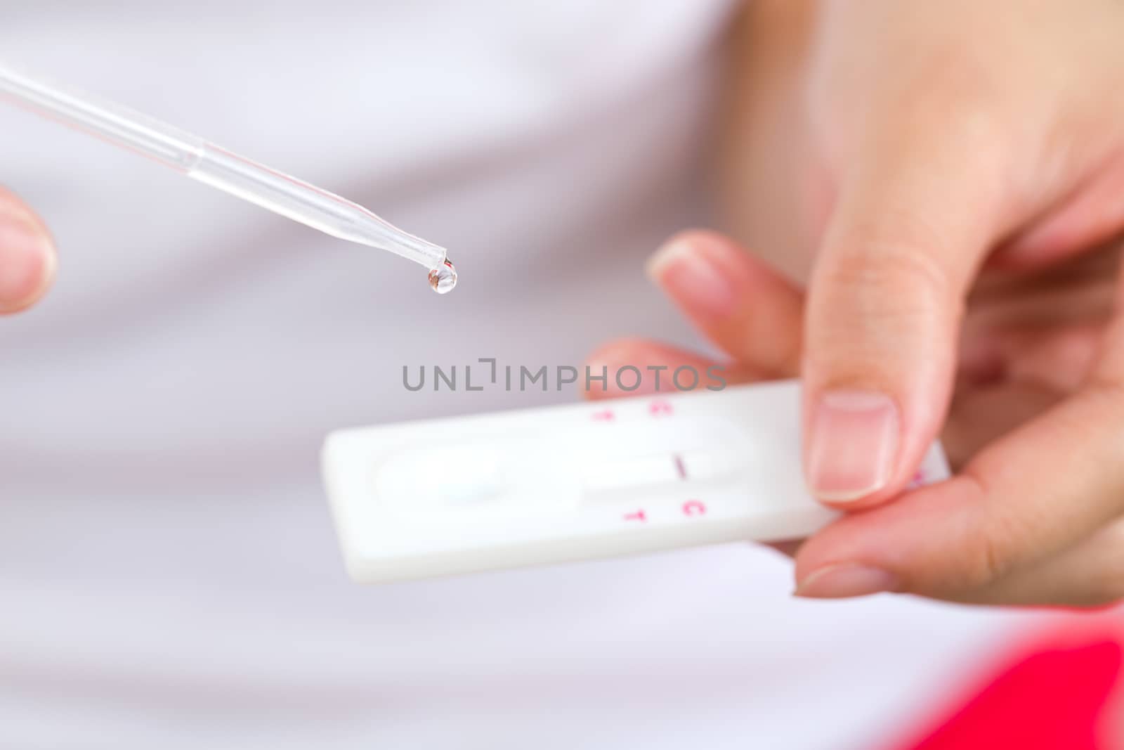 Young women checking pregnancy test. by jayzynism