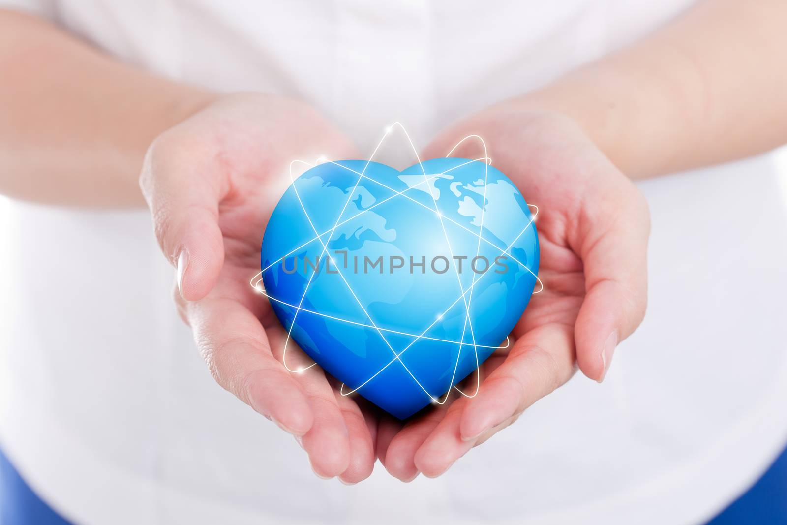 Female hands holding on earth global heart.
