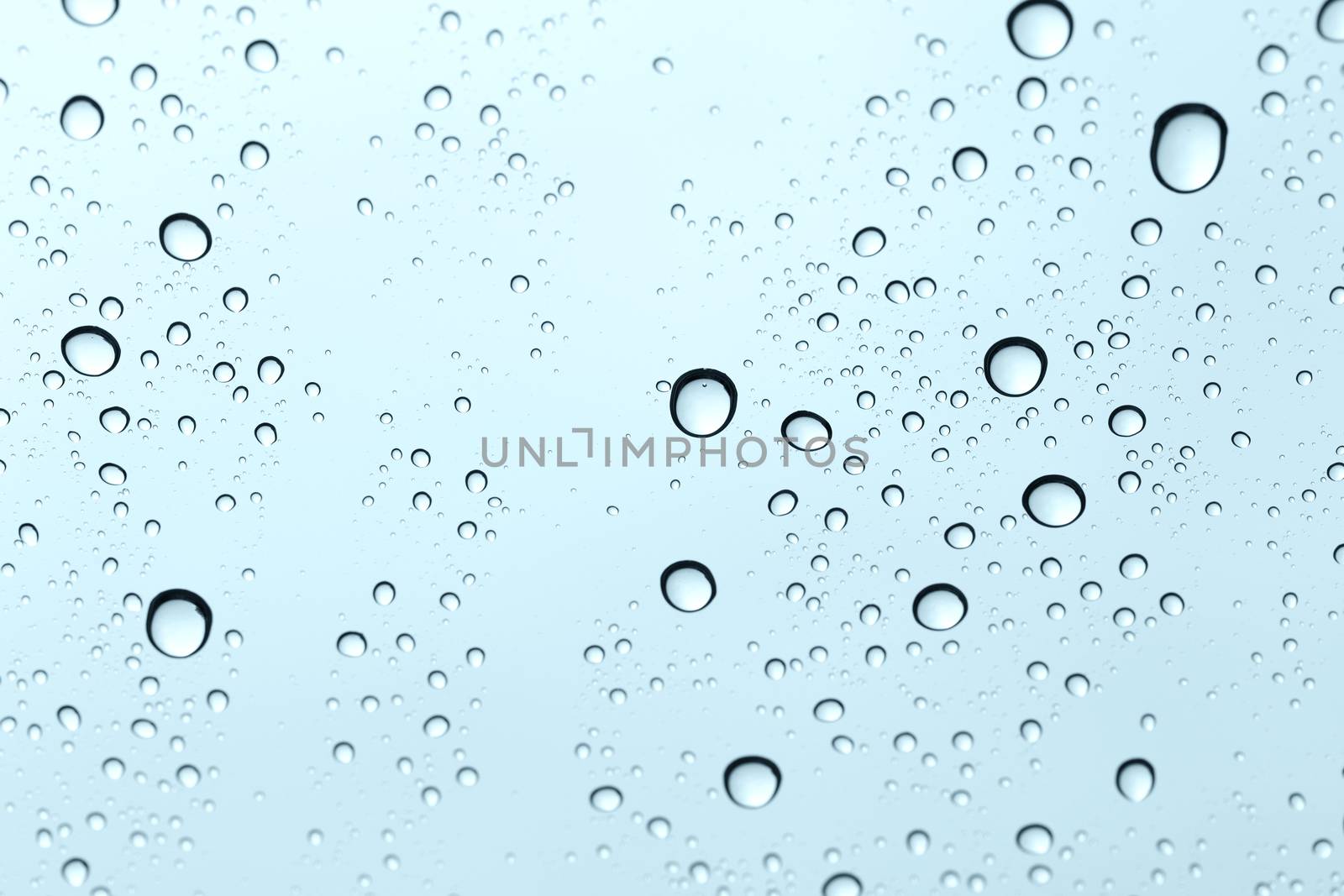 Water drop on glass mirror background. by jayzynism