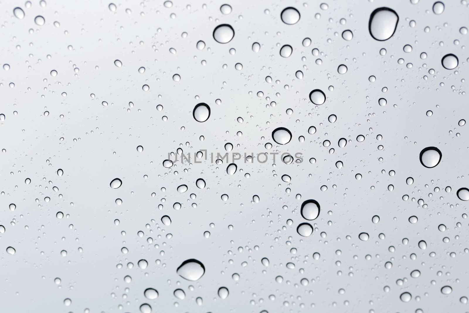 Water drop on glass mirror background.