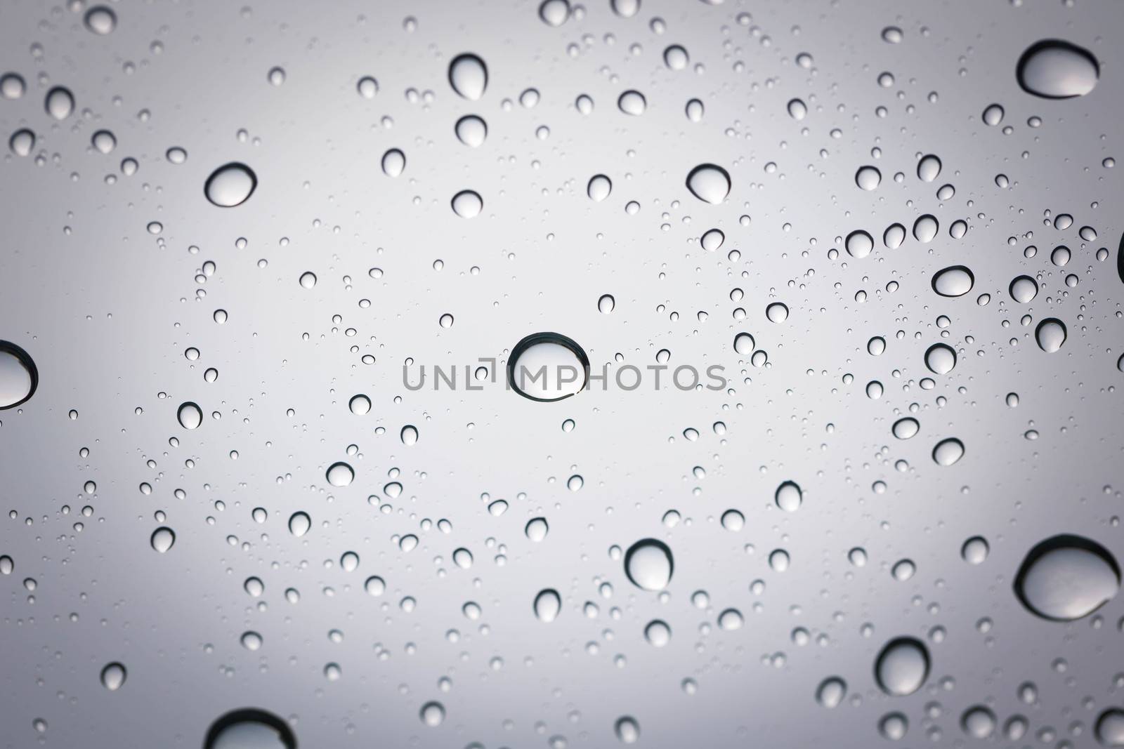 Water drop on glass mirror background. by jayzynism