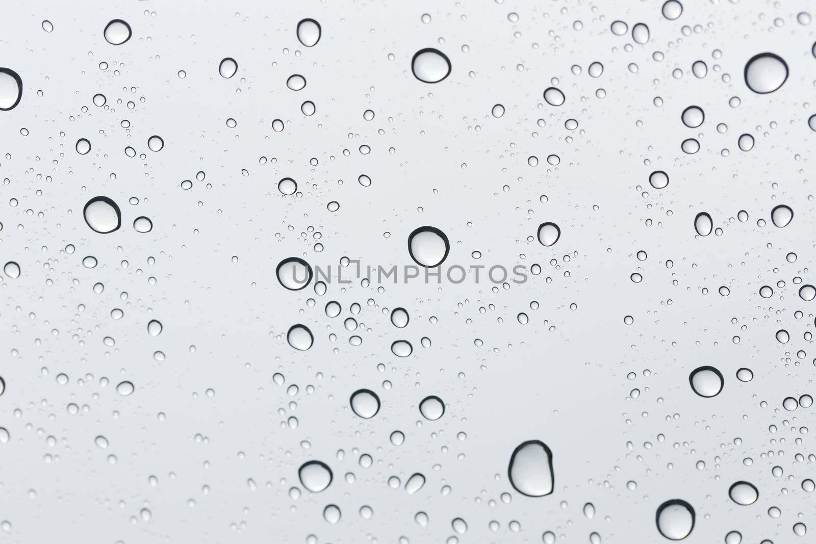 Water drop on glass mirror background.