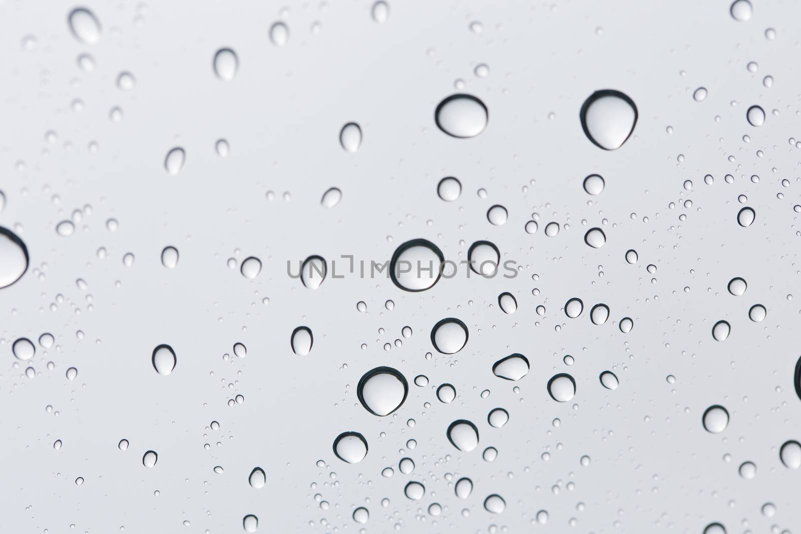 Water drop on glass mirror background.