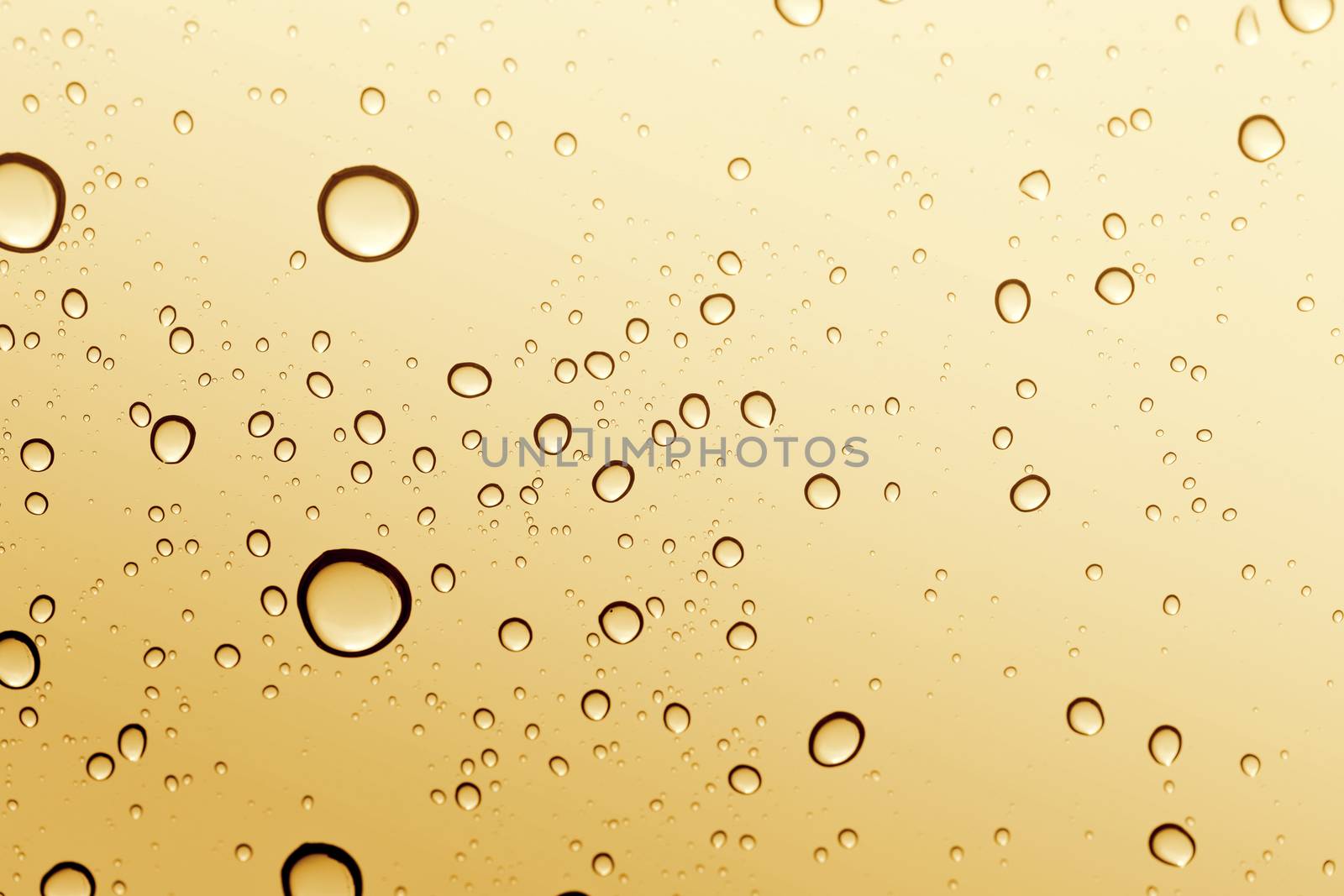 Gold water drop on glass mirror background. by jayzynism