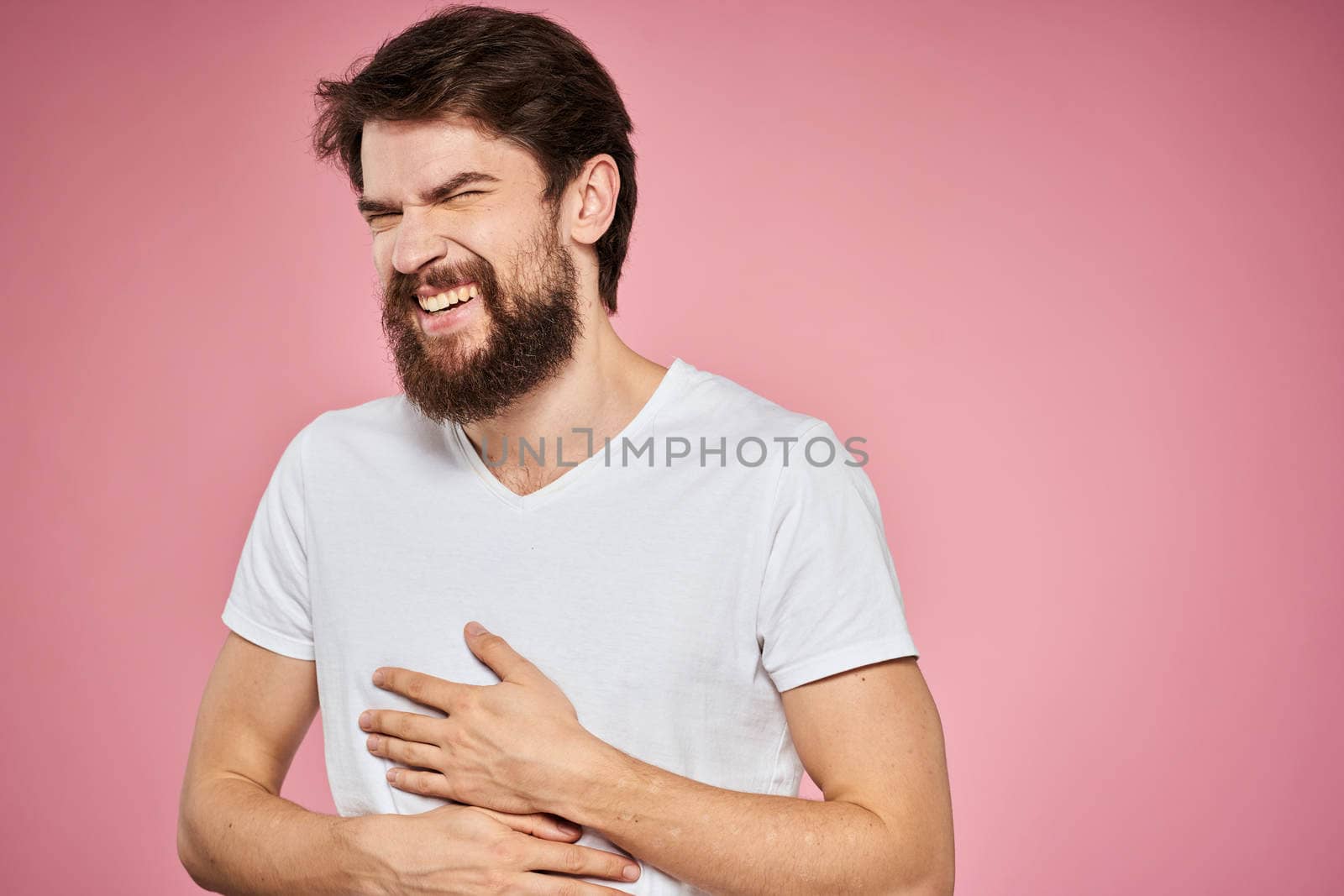 cheerful bearded man white t-shirt emotions cropped view pink background. High quality photo