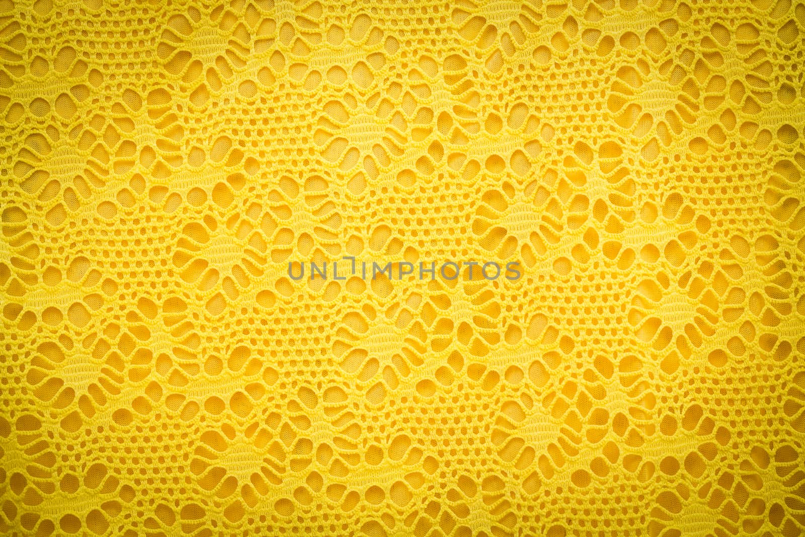 Yellow lace fabric background texture.