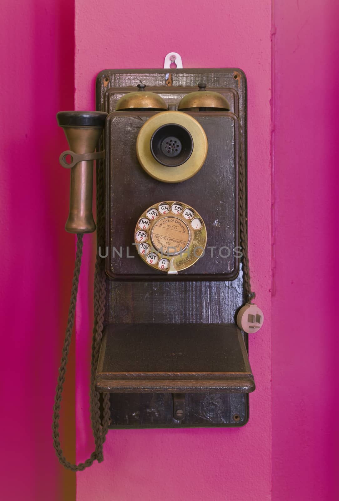 Antique vintage telephone purple grunge background.