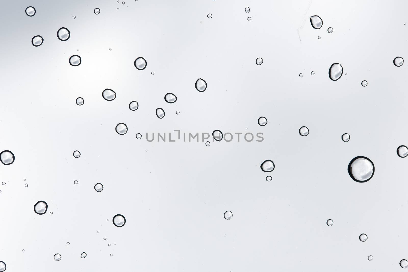 Water drop on glass mirror background. by jayzynism