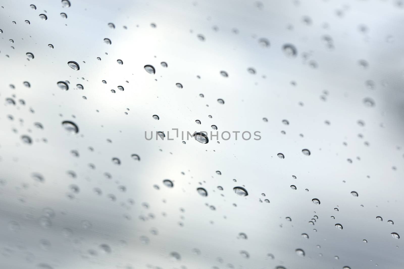 Water drop on glass mirror background.