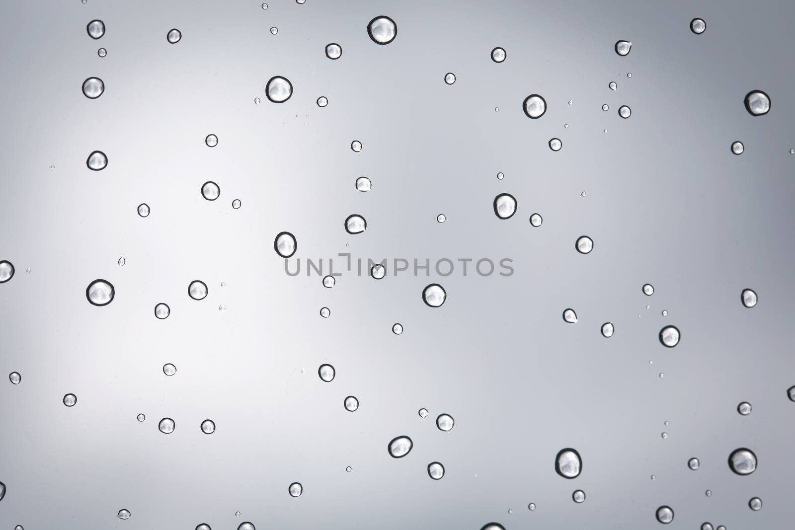 Water drop on glass mirror background. by jayzynism