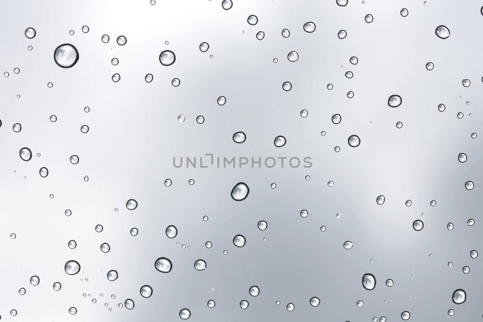 Water drop on glass mirror background.