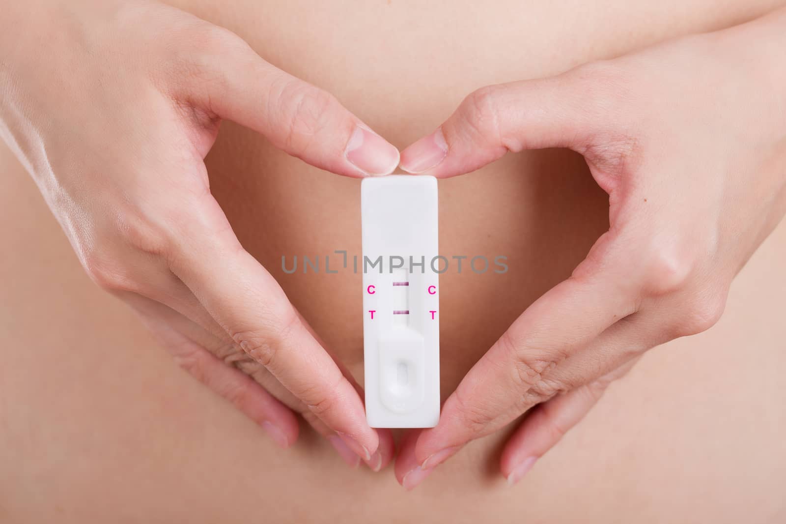 Close up pregnancy test with love women feeling happiness. by jayzynism