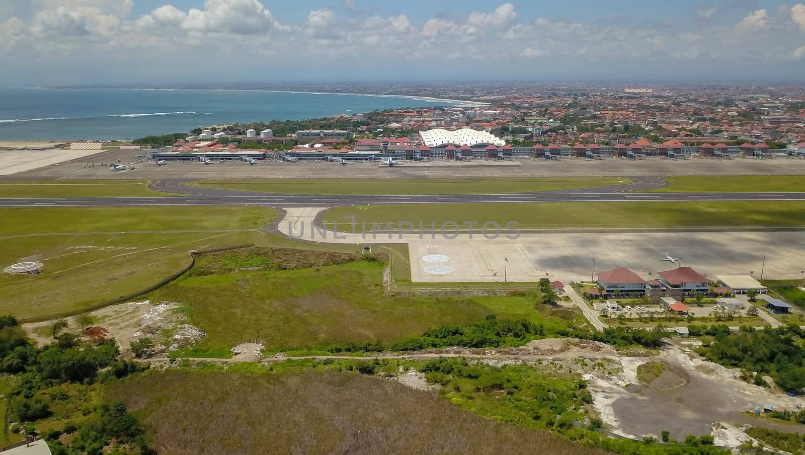 Airplanes at Balinese airport, Bali island, Indonesia. Aerial view to Ngurah Rai airport.