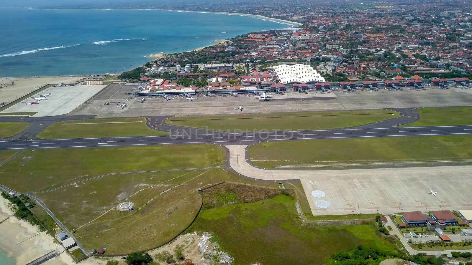 Airplanes at Balinese airport, Bali island, Indonesia. Aerial view to Ngurah Rai airport.