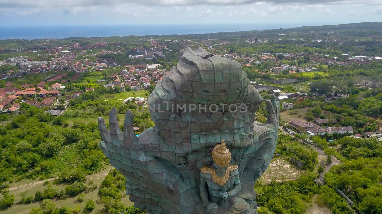 Landscape picture of tallest Garuda Wisnu Kencana GWK statue as Bali landmark with blue sky as a background. Balinese traditional symbol of hindu religion. Popular travel destinations in Indonesia by Sanatana2008