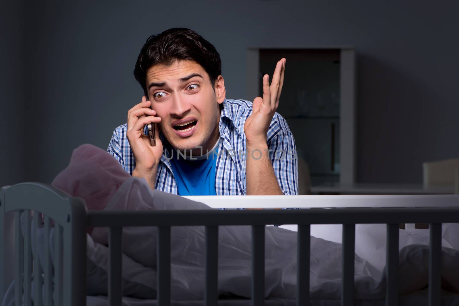 Young father under stress due to baby crying at night