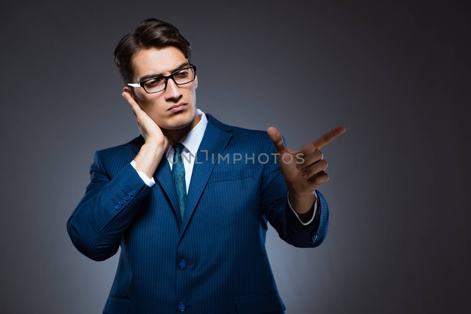 Businessman pressing virtual buttons on gray background
