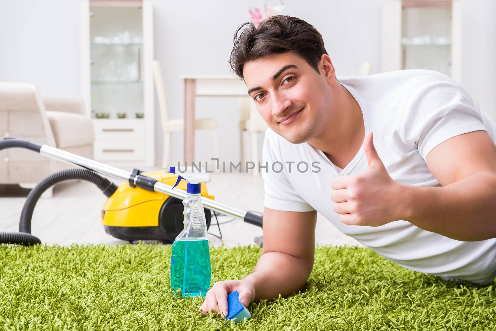 Young husband man cleaning floor at home