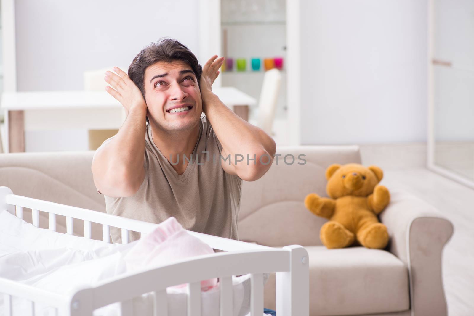 Young father dad frustrated at crying baby