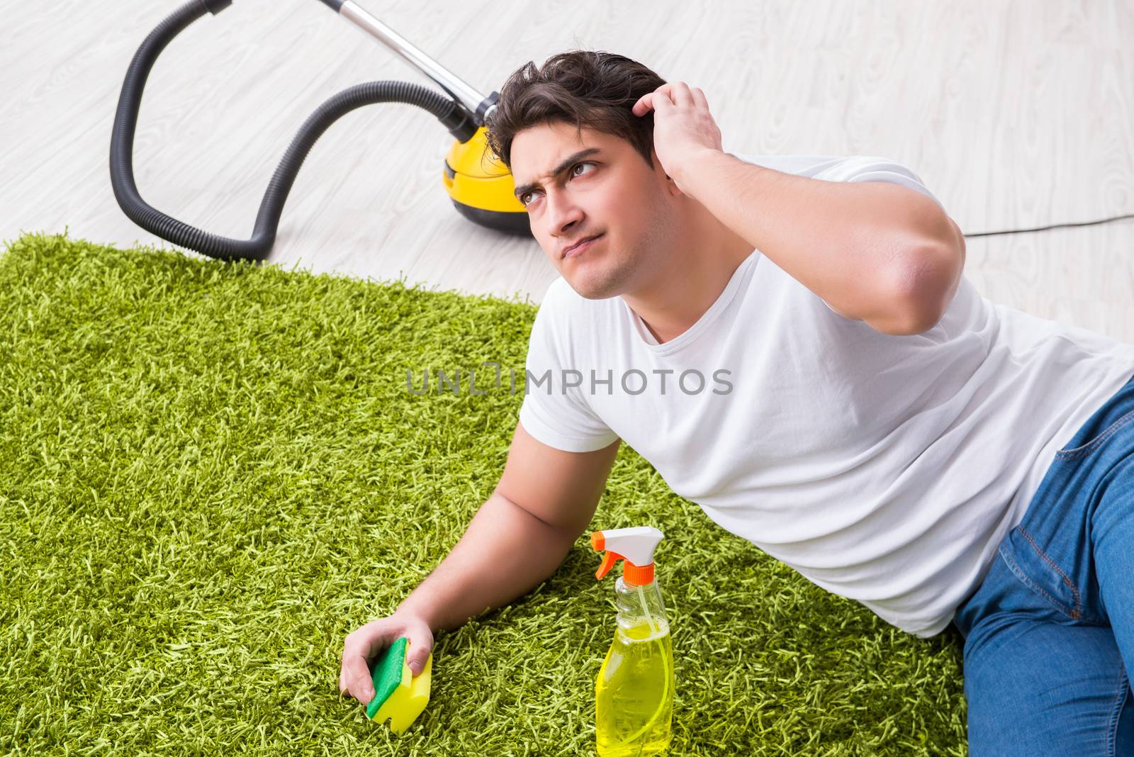 Young husband man cleaning floor at home
