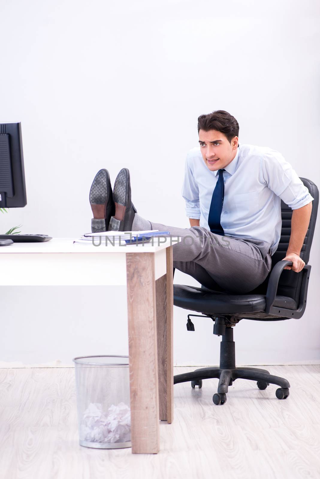 Businessman doing sports in office during break by Elnur