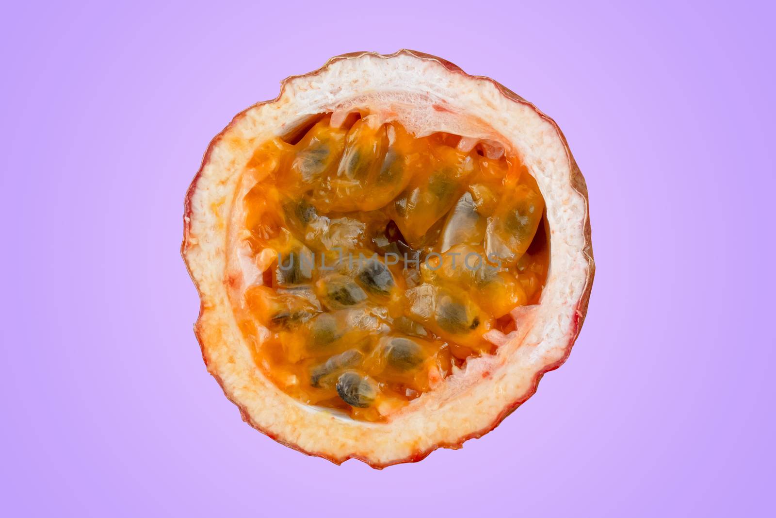 Maracuja cut in half and whole with leaf on violet background. Passion fruit yellow with fruit juice and seeds
