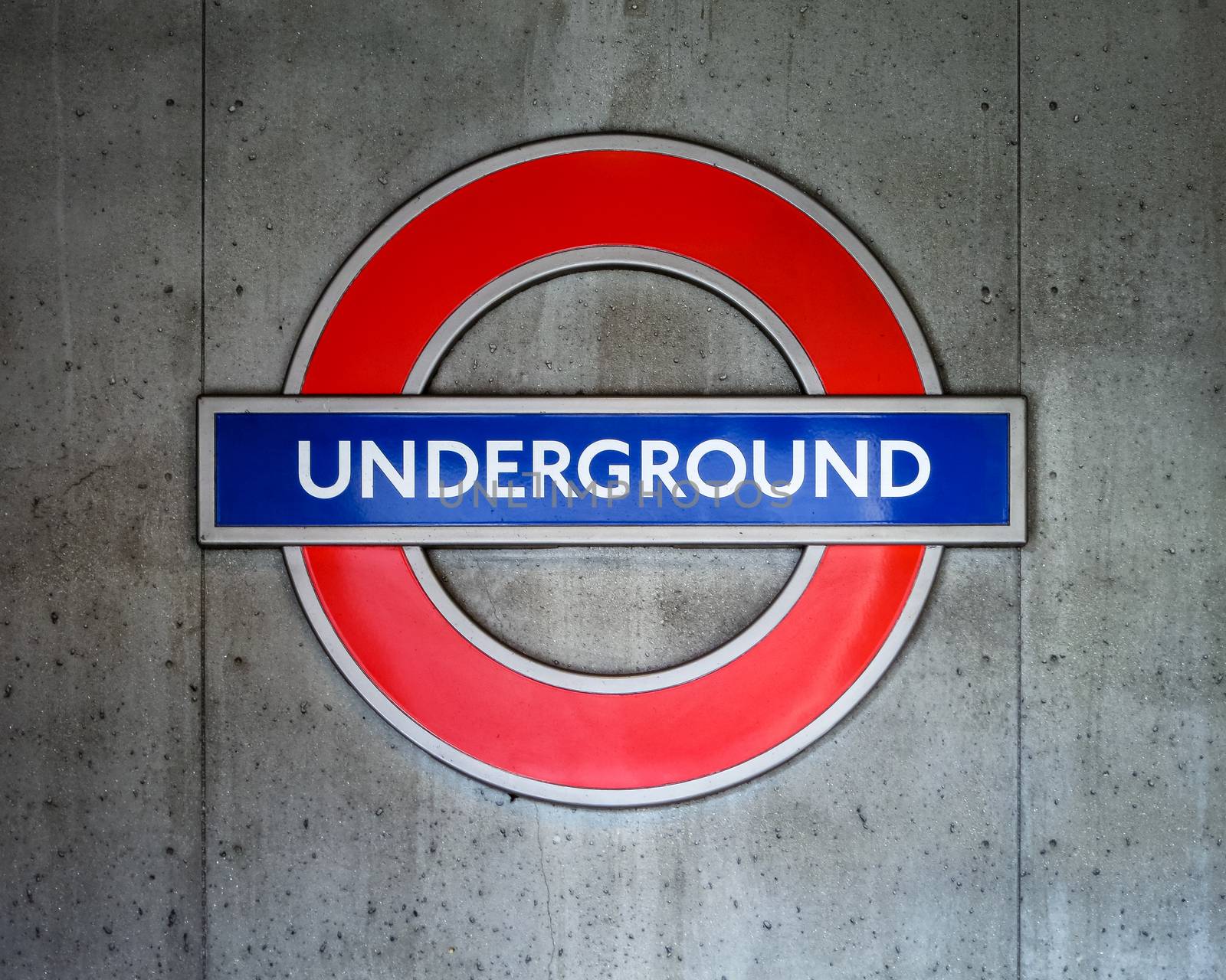 London Underground sign on concrete wall by dutourdumonde