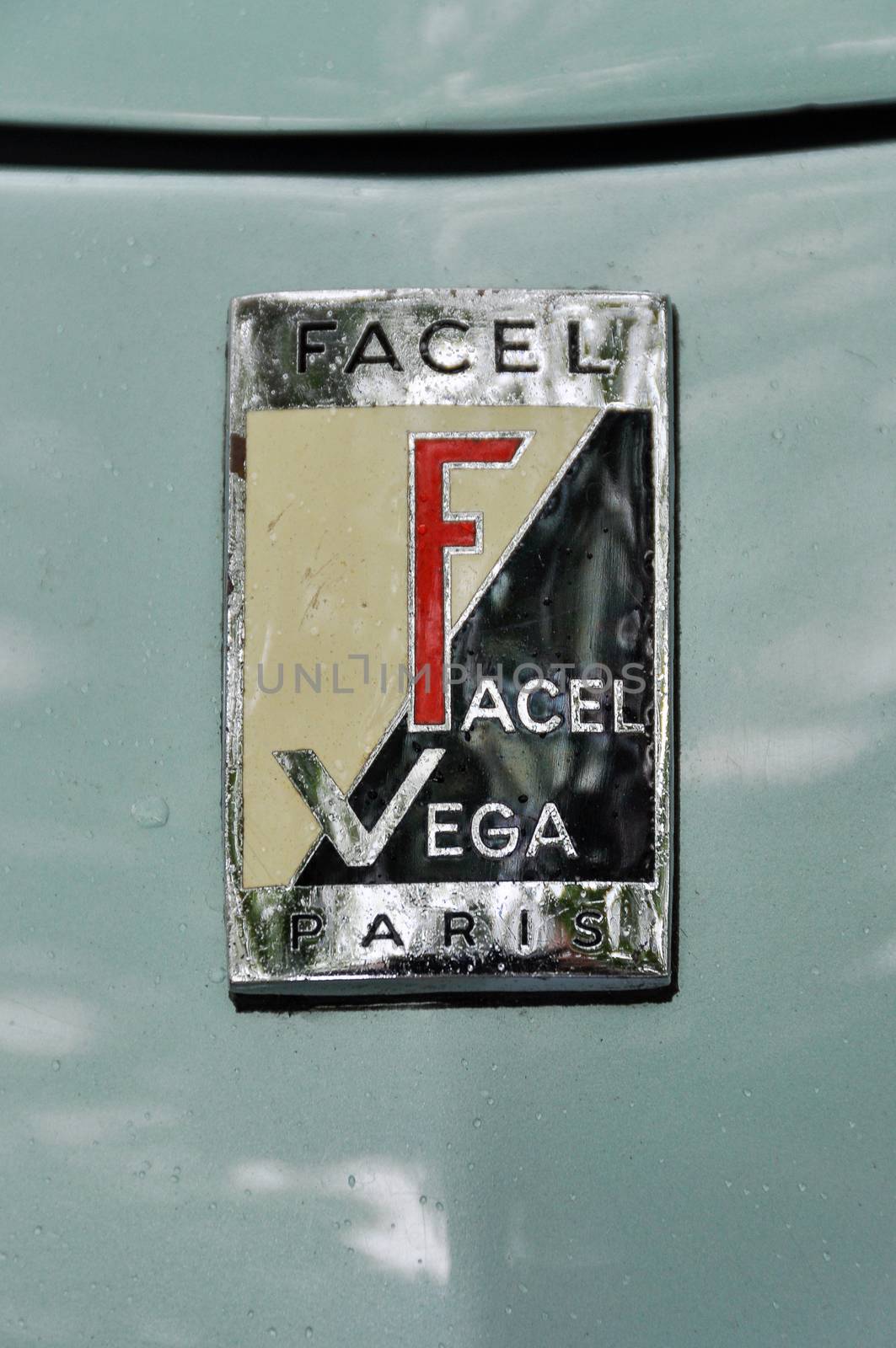 LONDON, UK - CIRCA SEPTEMBER 2011: Facel-Vega logo on green bodywork. Facel-Vega was a French car manufacturer between 1954 and 1964.