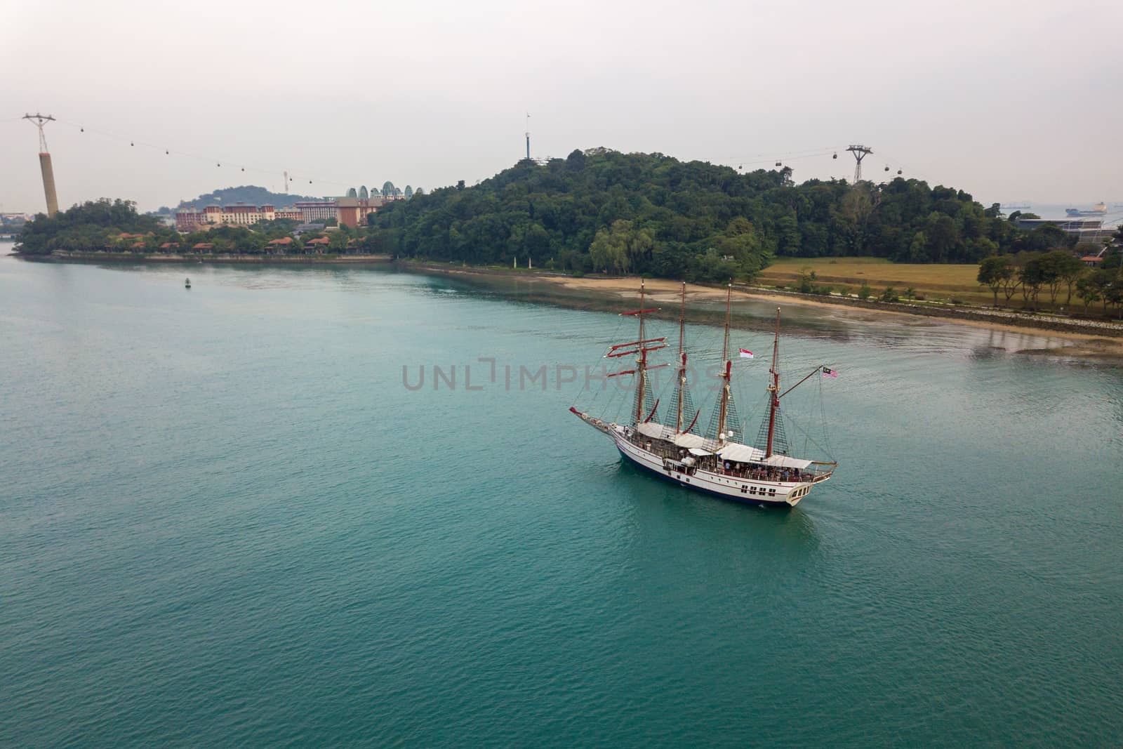 SINGAPORE - CIRCA MARCH 2019: Aerial view of an old sailing boat entering Keppel Bay.