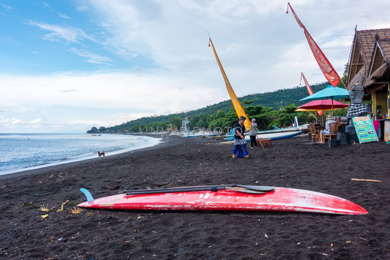 Red paddle board on the black sand beach in Amed, Bali, Indonesia