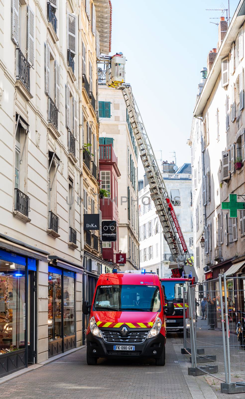 BAYONNE, FRANCE - 21 MAY, 2020: Firemen on top of ladder evacuate somebody through window.