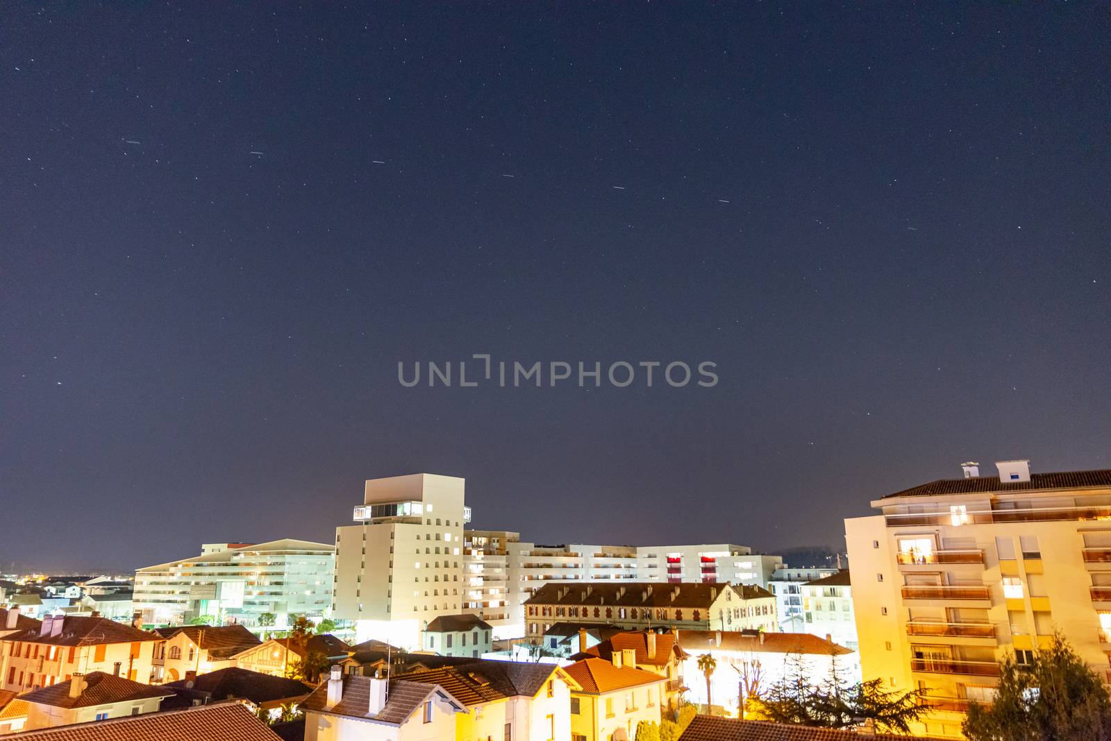 BAYONNE, FRANCE - JANUARY 20, 2020: Time-lapse of SpaceX Starlink satellites in the night sky. The Starlink satellite constellation is under construction and will provide satellite internet access.