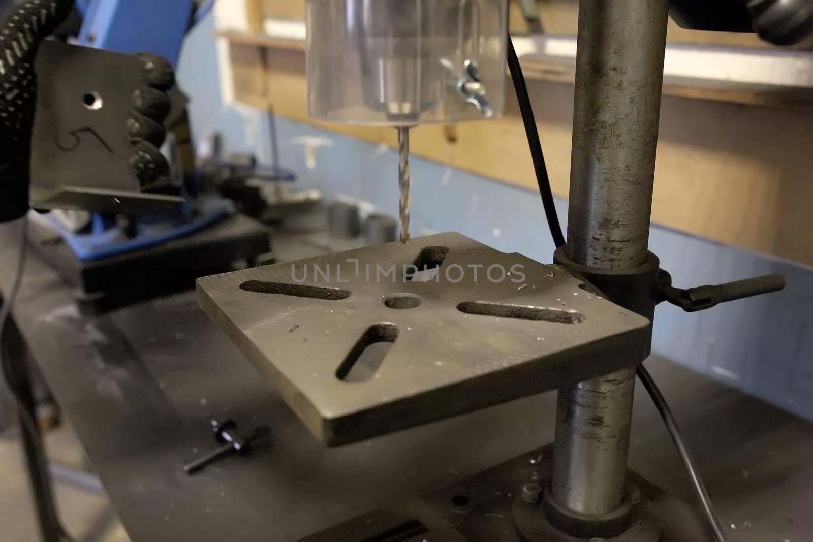 drill press with a drill inserted. Metal drilling. The drill rotates