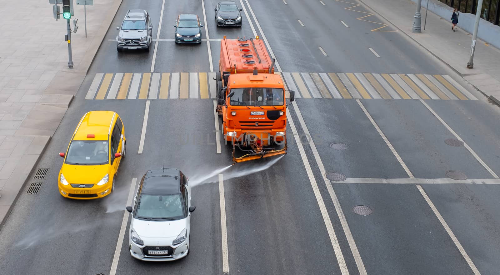 October 7, 2020, Moscow, Russia. Utility vehicles watering the street on a cloudy day.