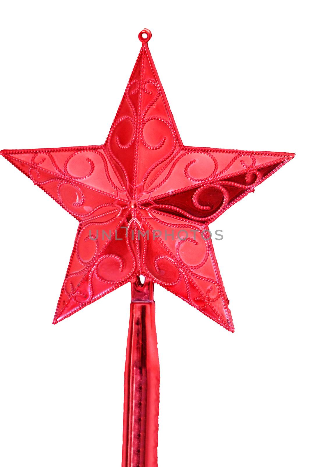 Shining red star set high up on white christmas tree. No people