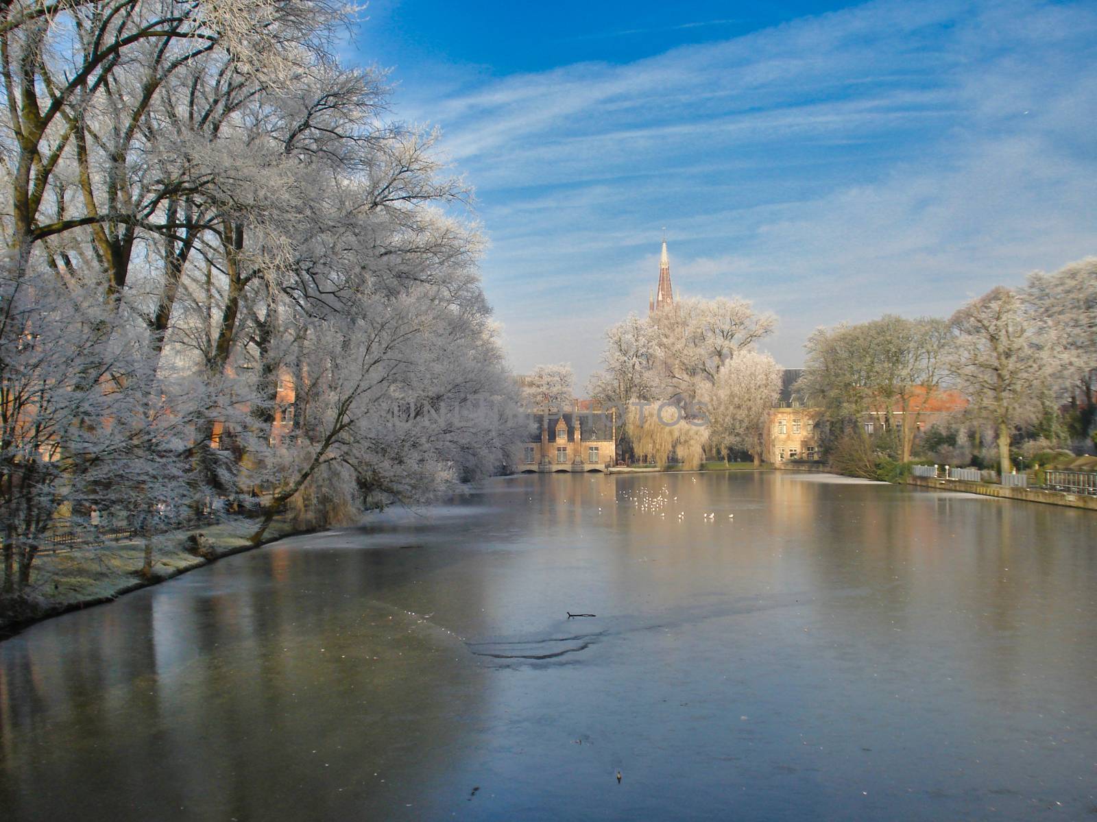 Bruges, Belgium, December 2007: Winter in Bruges, Belgium, with view on Minnewaterpark in frost against blue sky
