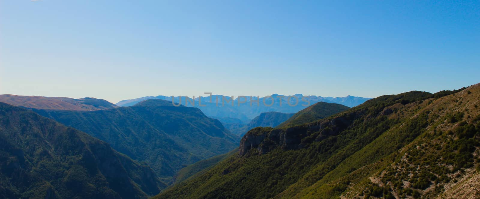 Banner of many mountain peaks and hills observed above the old Bosnian village of Lukomir. Mountain peaks and hills. Bjelasnica Mountain, Bosnia and Herzegovina.