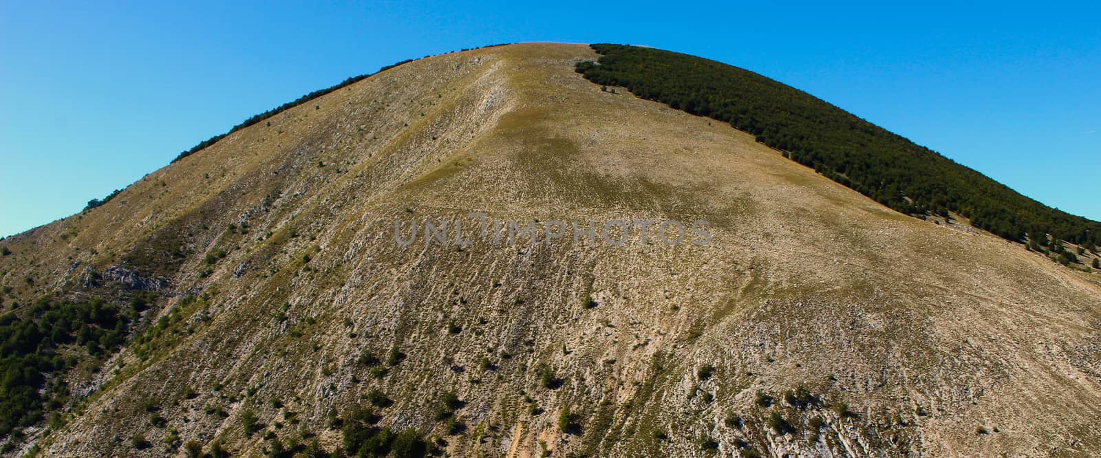 Banner of a huge hill above the old Bosnian village of Lukomir, which is quite devoid of vegetation due to soil erosion. Bjelasnica Mountain, Bosnia and Herzegovina.