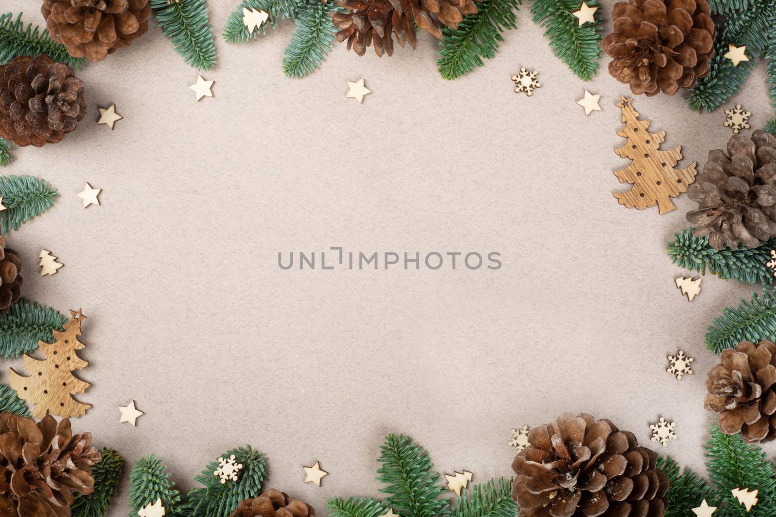Christmas card light background with wooden decor fir tree branches border frame with copy space