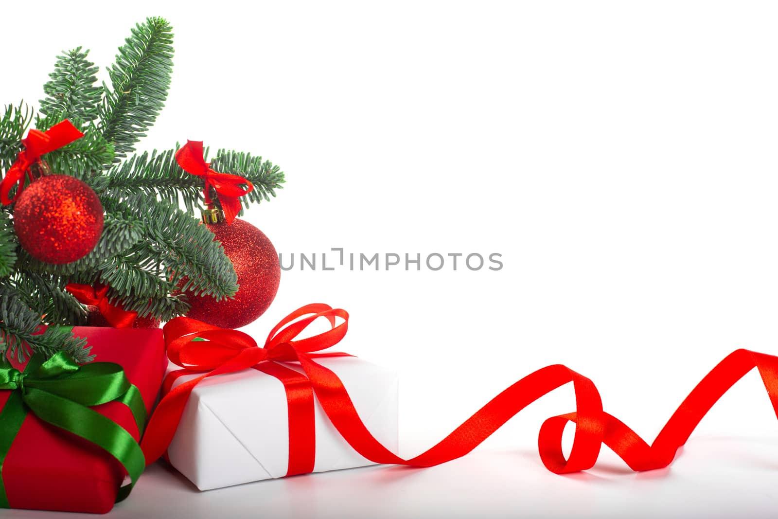 White holiday present gift boxes with red satin bow and curly ribbon under Christmas tree with baubles, border frame design isolated on white background