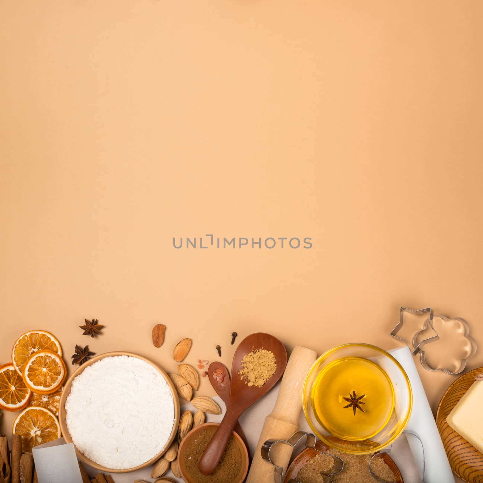 Christmas gingerbread cookies cooking background flat lay top view template with copy space for text. Baking utensils, spices and food ingredients on brown paper background