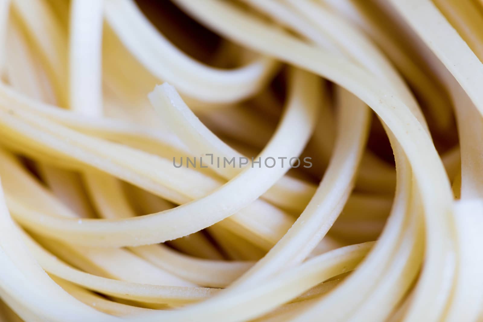 Closeup view of a Pile Of Uncooked Rolled Traditional Italian Pasta.