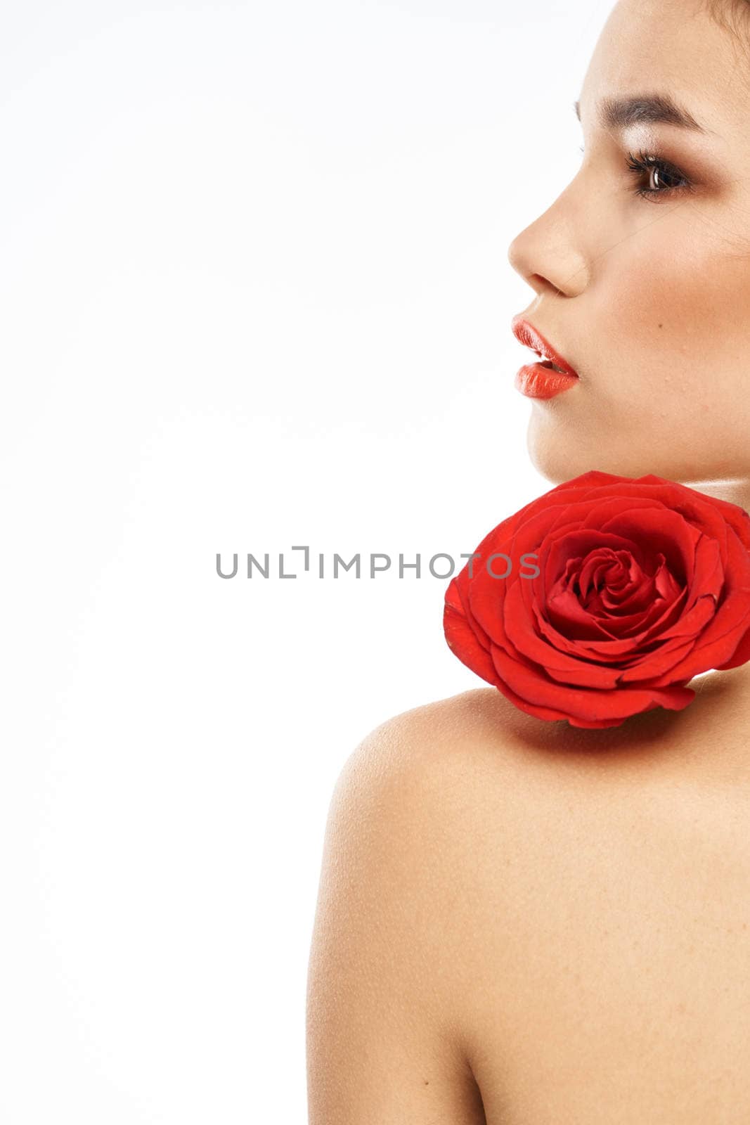 Portrait of woman with red rose naked shoulders Make-up on brunette face by SHOTPRIME