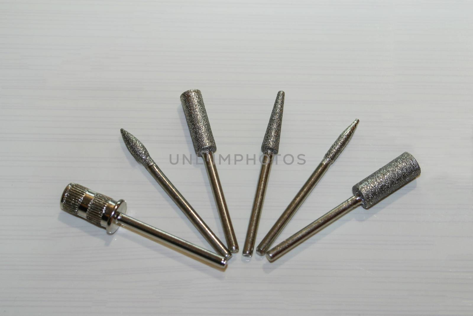 Set of six milling cutters. Manicure tool. Used manicurist professional tools on a white background.