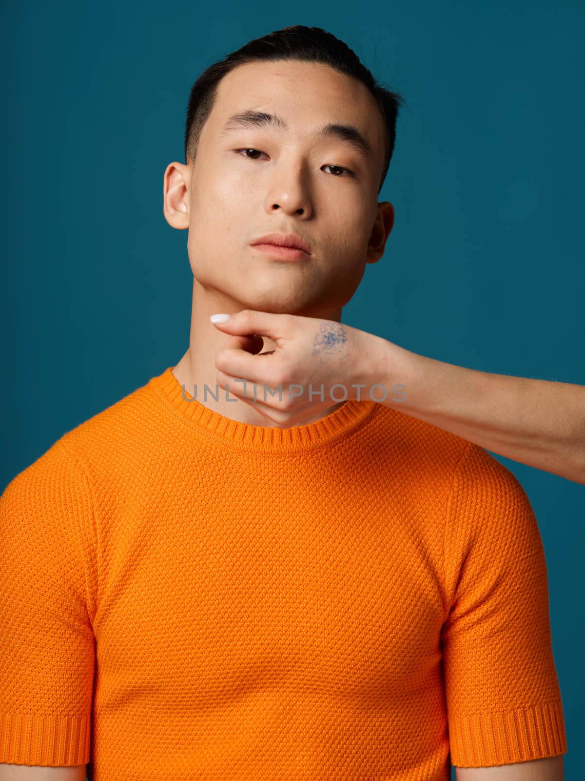 A Korean country man in an orange T-shirt and a woman's hand near the face by SHOTPRIME