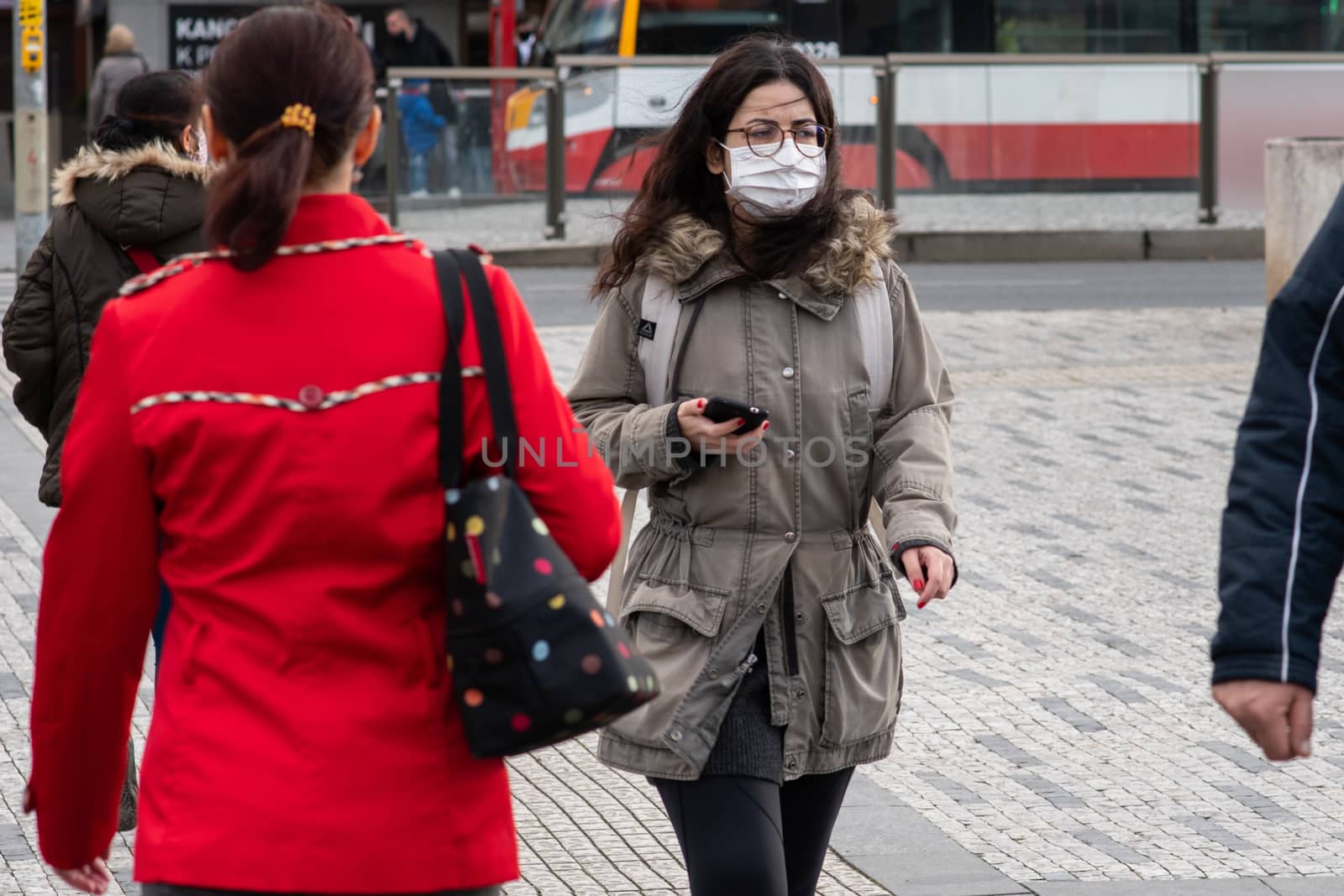 11/16/2020. Prague. Czech Republic. A woman wearing a mask is crossing the railways at Hradcanska tram stop during quarantine. by gonzalobell