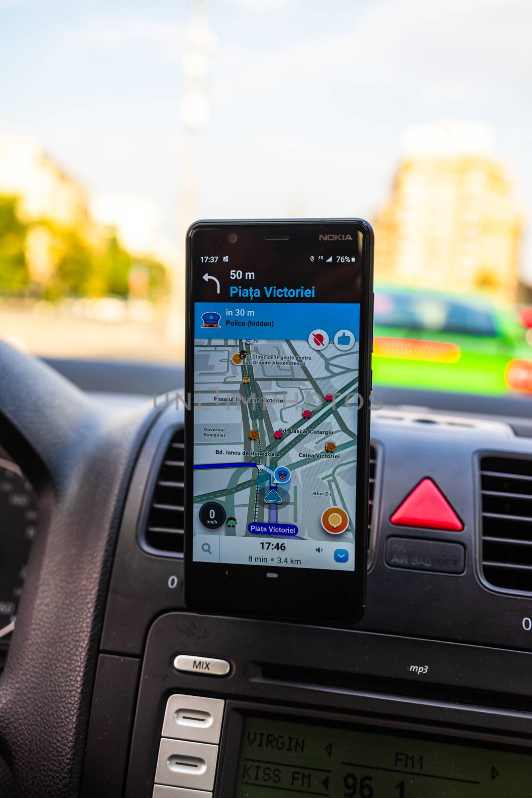 In car dashboard view with smartphone showing Police on Waze maps. Driver using Waze maps in Bucharest, Romania, 2020